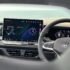 Modern car dashboard with digital display and steering wheel